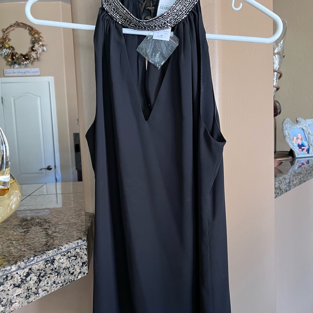Elegant Black Sleeveless Top with Embellished Neckline